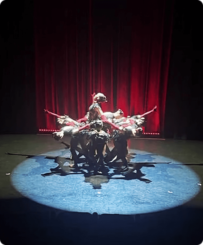 Artistic performance on stage with red curtains