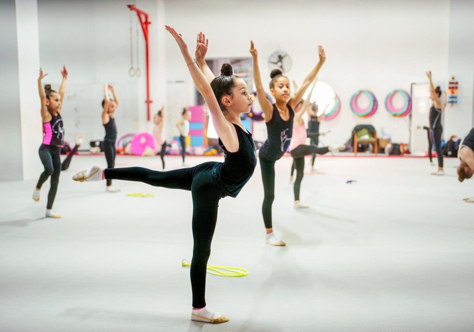 Children practicing ballet poses in class