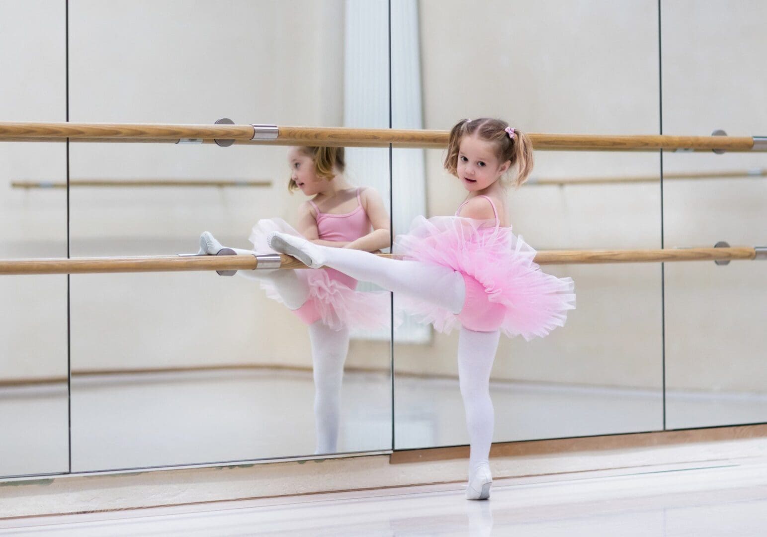 Child ballet dancer in studio mirror