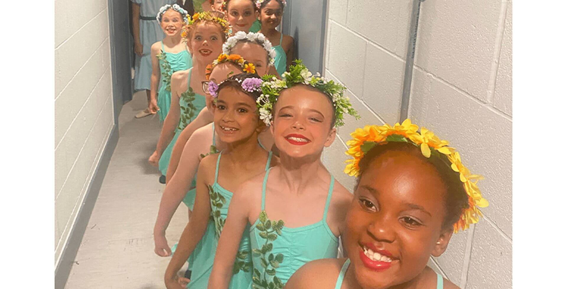 Young dancers lined up in costumes