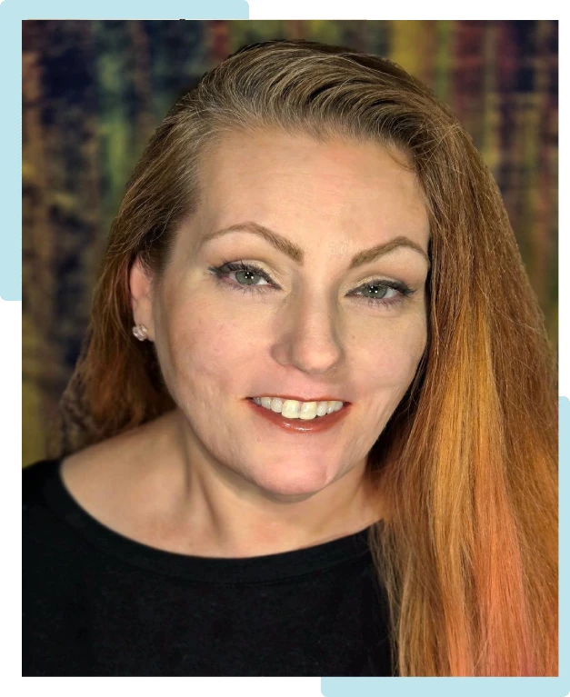 Smiling woman with long red hair and light makeup.
