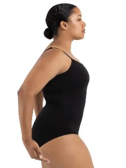 Woman in black sleeveless bodysuit, side view.