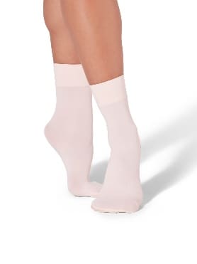 Legs wearing light pink ankle socks.